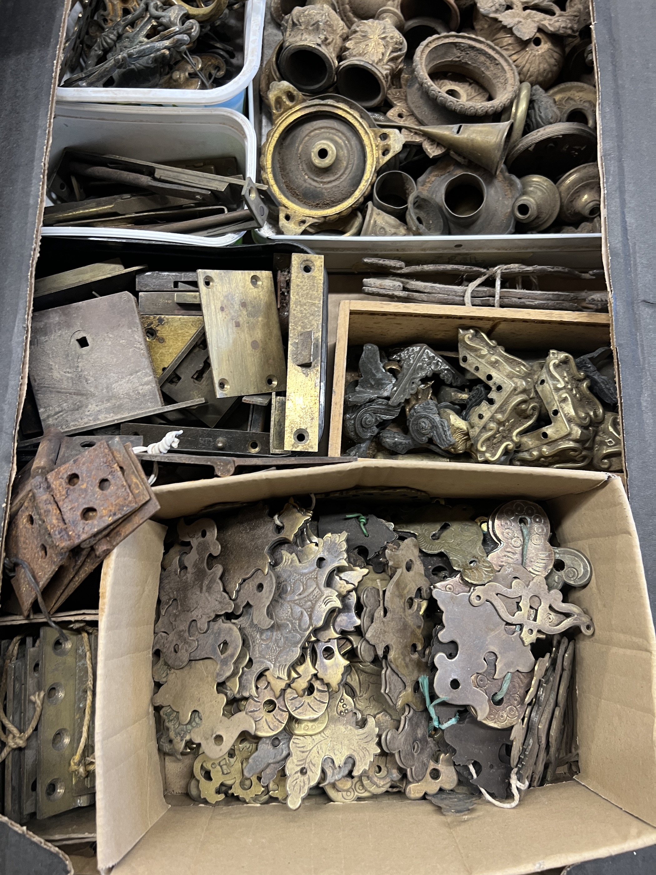 A quantity of assorted brass furniture mounts, escutcheons, locks, hinges, etc.